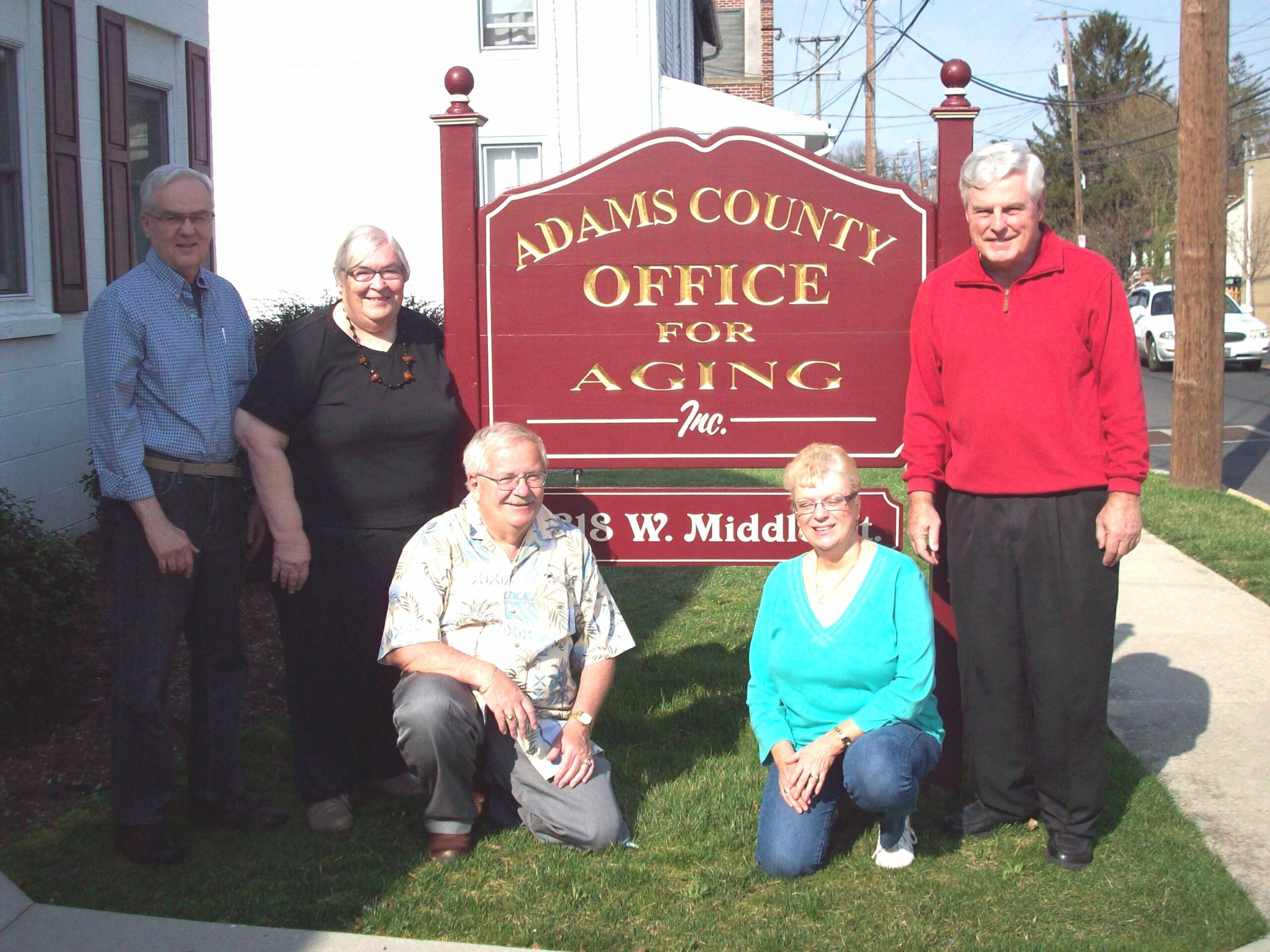 ACOFA team posing by sign